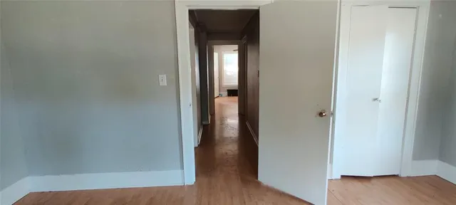 a view of hallway with wooden floor