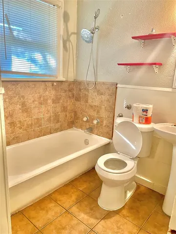a bathroom with a toilet and a bathtub