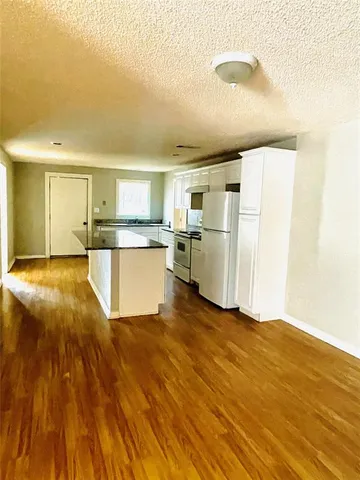 a kitchen with stainless steel appliances a refrigerator and a stove top oven