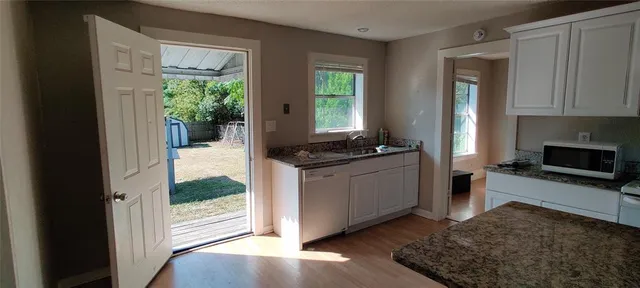 a kitchen with sink and cabinets