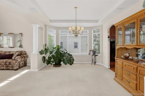 a living room with furniture a potted plant and a fireplace