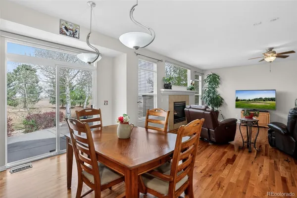 a kitchen with stainless steel appliances granite countertop a stove a sink dishwasher and a refrigerator with wooden floor