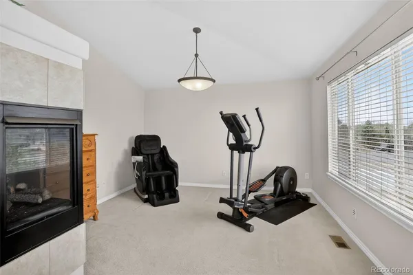 a bathroom with a granite countertop sink a toilet a mirror and shower