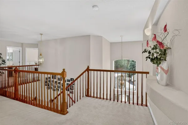 a bed sitting in a bedroom next to a window with outer view