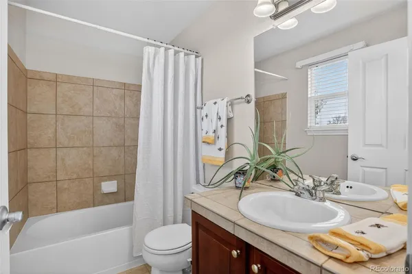 a bedroom with a bed dresser and a window