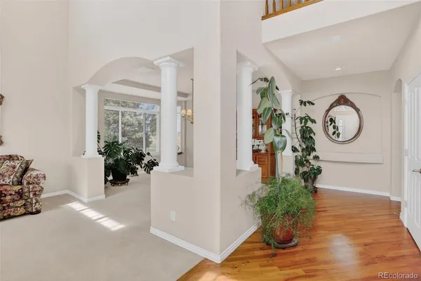 a living room with furniture flowerpot and a window