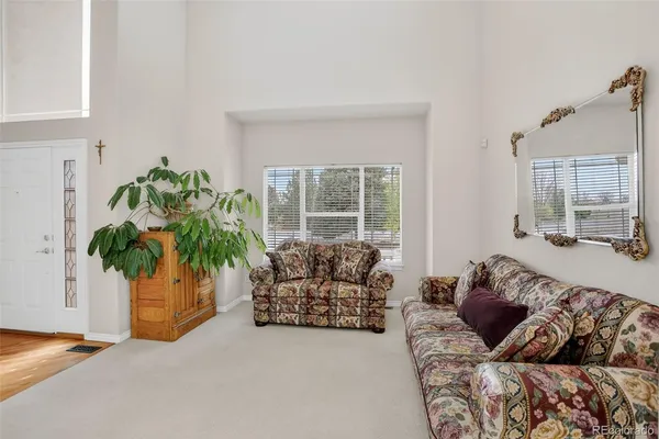 a view of a livingroom with furniture and staircase