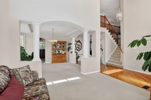 a living room with furniture and a chandelier