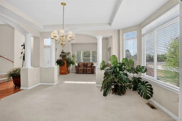a living room with furniture and a chandelier