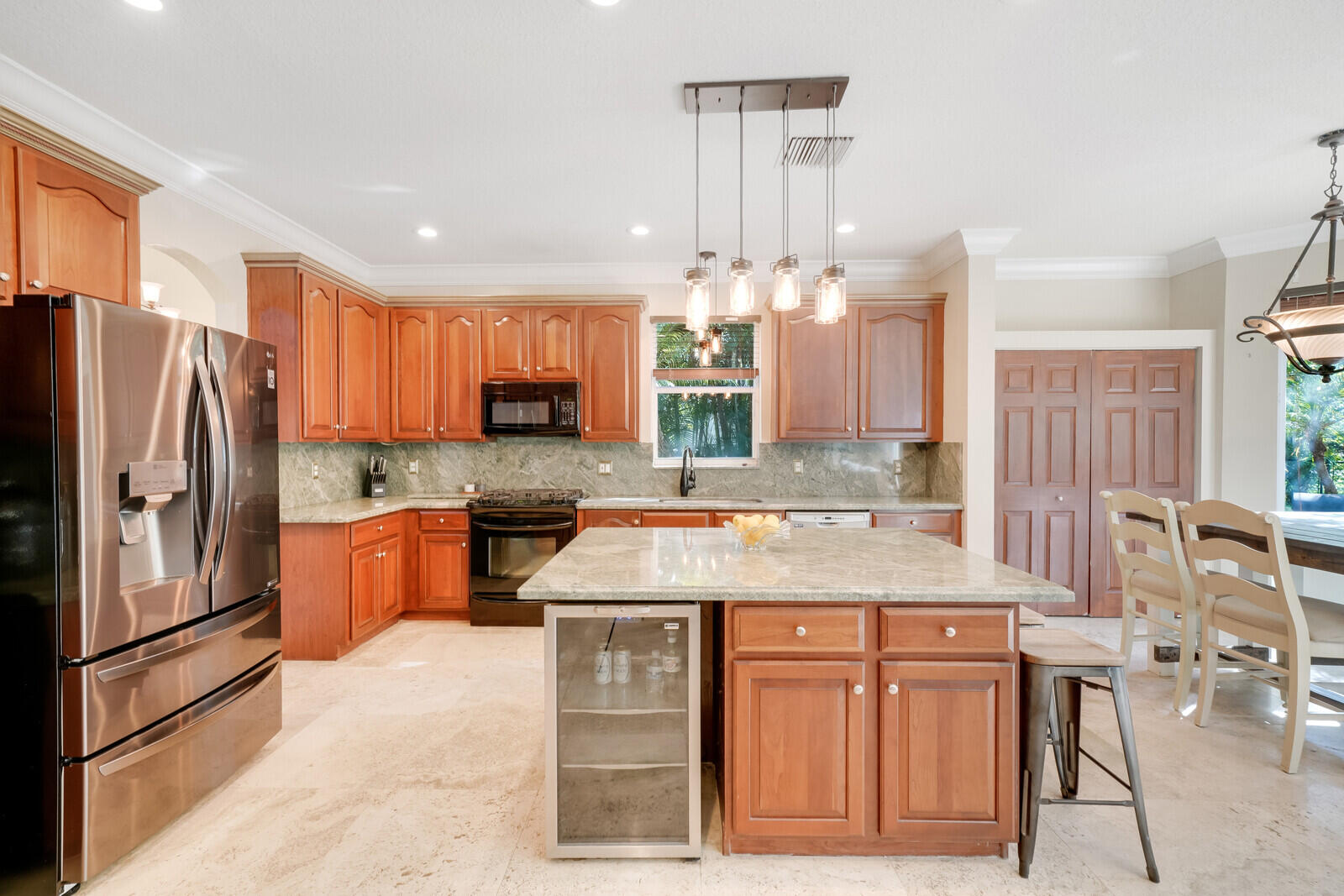 202 Anhinga Lane Jupiter, FL 33458 - Photo 12 of 40 a kitchen with stainless steel appliances granite countertop a sink refrigerator and cabinets