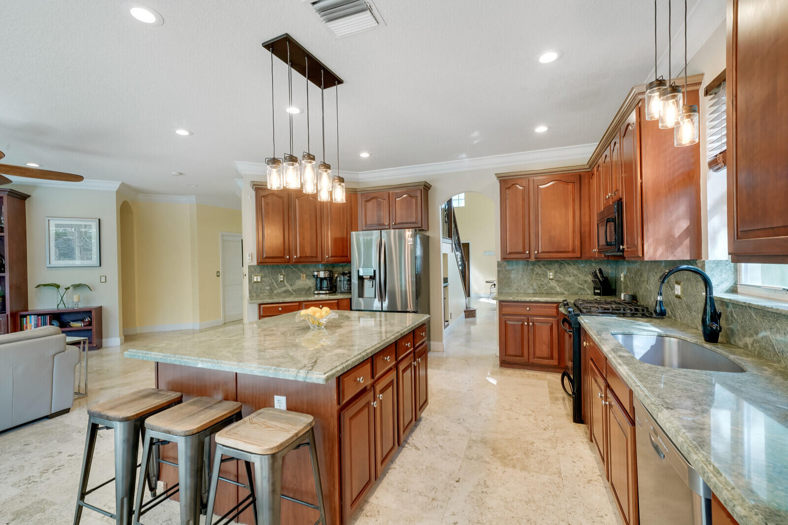202 Anhinga Lane Jupiter, FL 33458 - Photo 14 of 40 a kitchen with granite countertop a sink a counter top space and stainless steel appliances