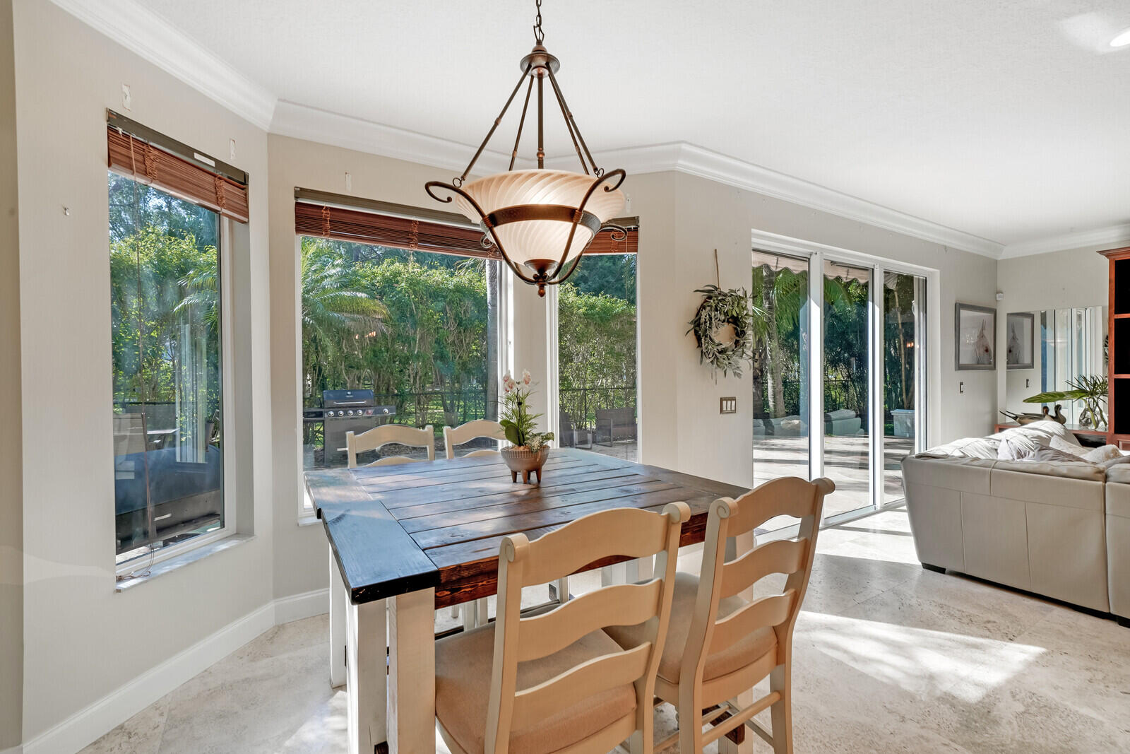 202 Anhinga Lane Jupiter, FL 33458 - Photo 15 of 40 a dining room with furniture a chandelier and wooden floor