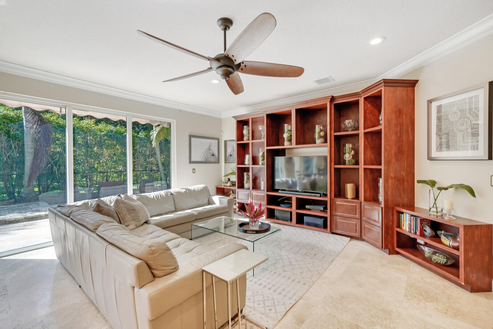 202 Anhinga Lane Jupiter, FL 33458 - Photo 16 of 40 a living room with furniture gym equipment and a flat screen tv