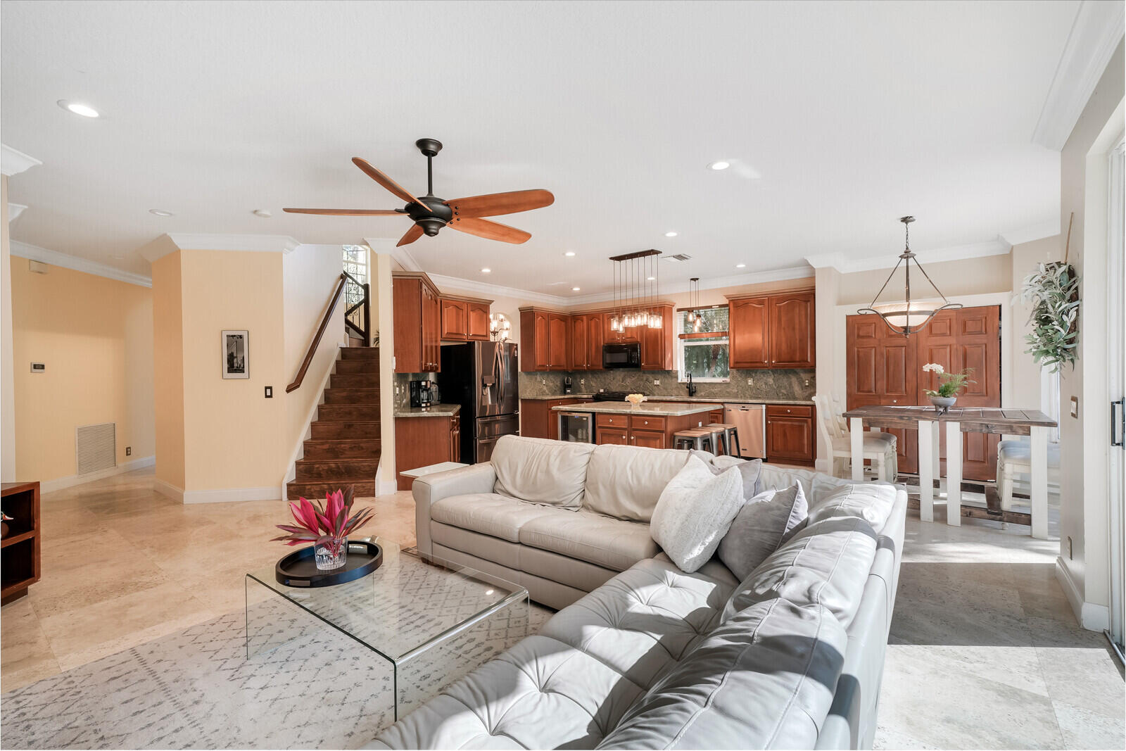 202 Anhinga Lane Jupiter, FL 33458 - Photo 18 of 40 a living room with furniture kitchen view and a chandelier