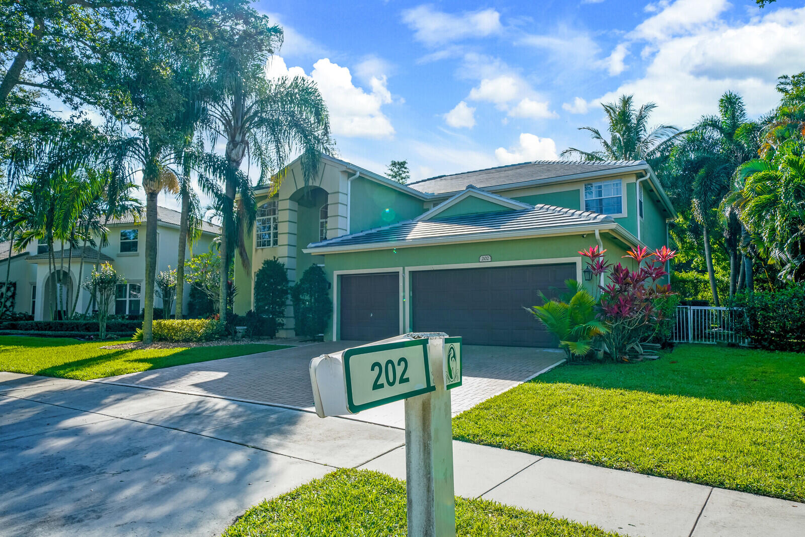 202 Anhinga Lane Jupiter, FL 33458 - Photo 2 of 40 a front view of a house with garden