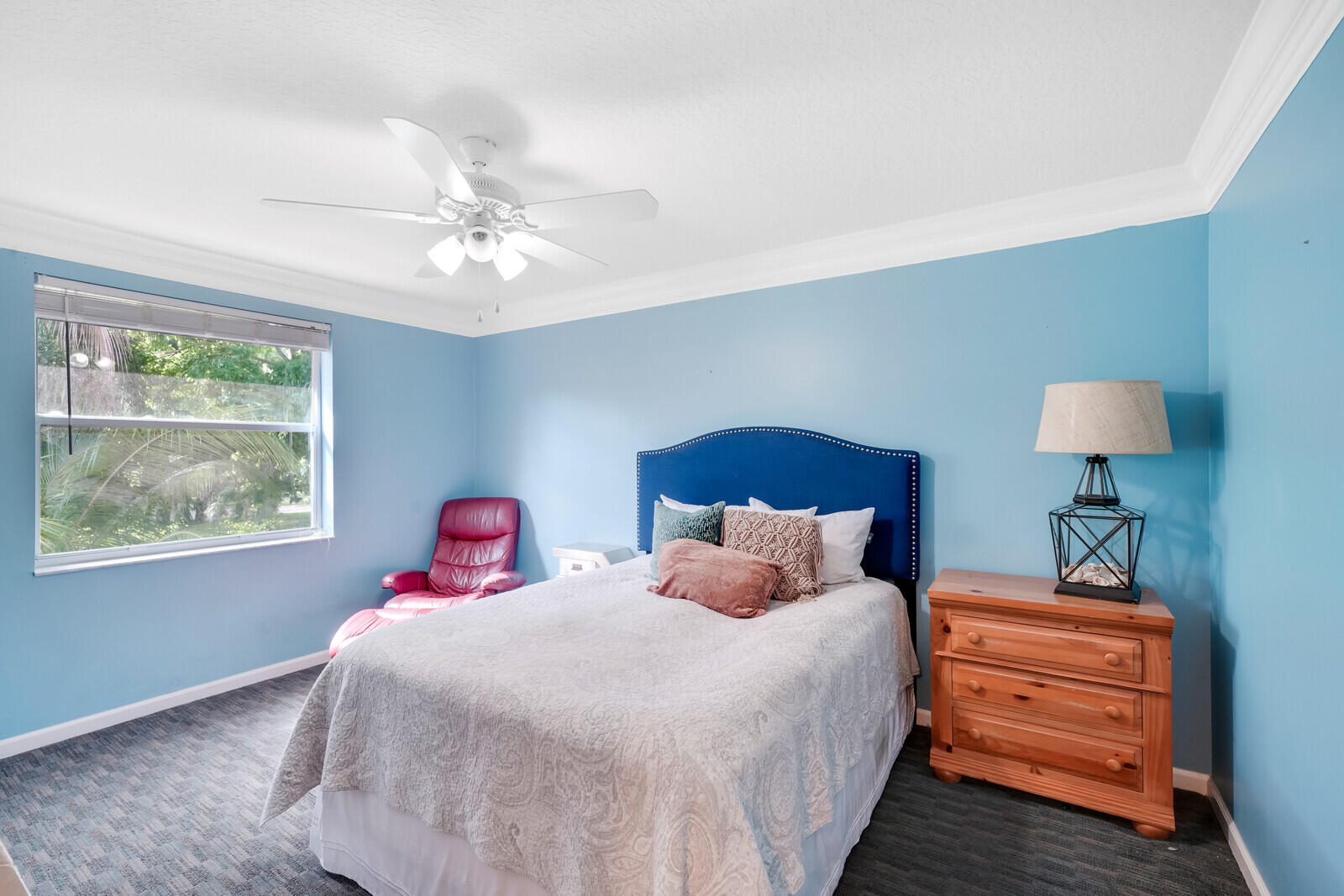 202 Anhinga Lane Jupiter, FL 33458 - Photo 30 of 40 a bedroom with a bed and a chandelier