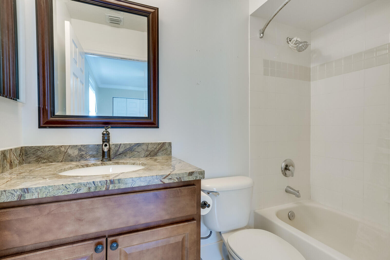 202 Anhinga Lane Jupiter, FL 33458 - Photo 35 of 40 a bathroom with a granite countertop sink toilet and mirror