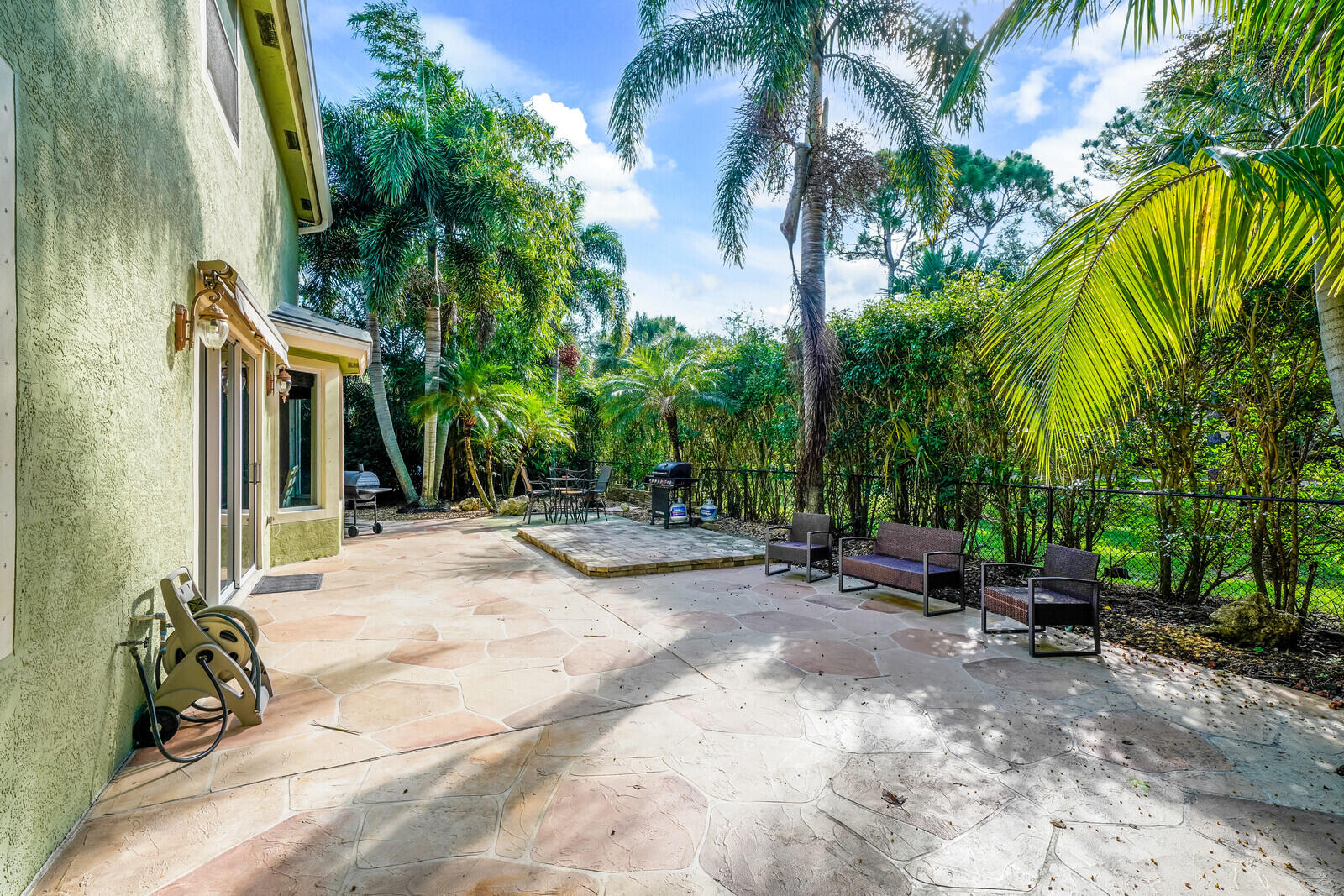 202 Anhinga Lane Jupiter, FL 33458 - Photo 36 of 40 a view of backyard with potted plants and a palm tree