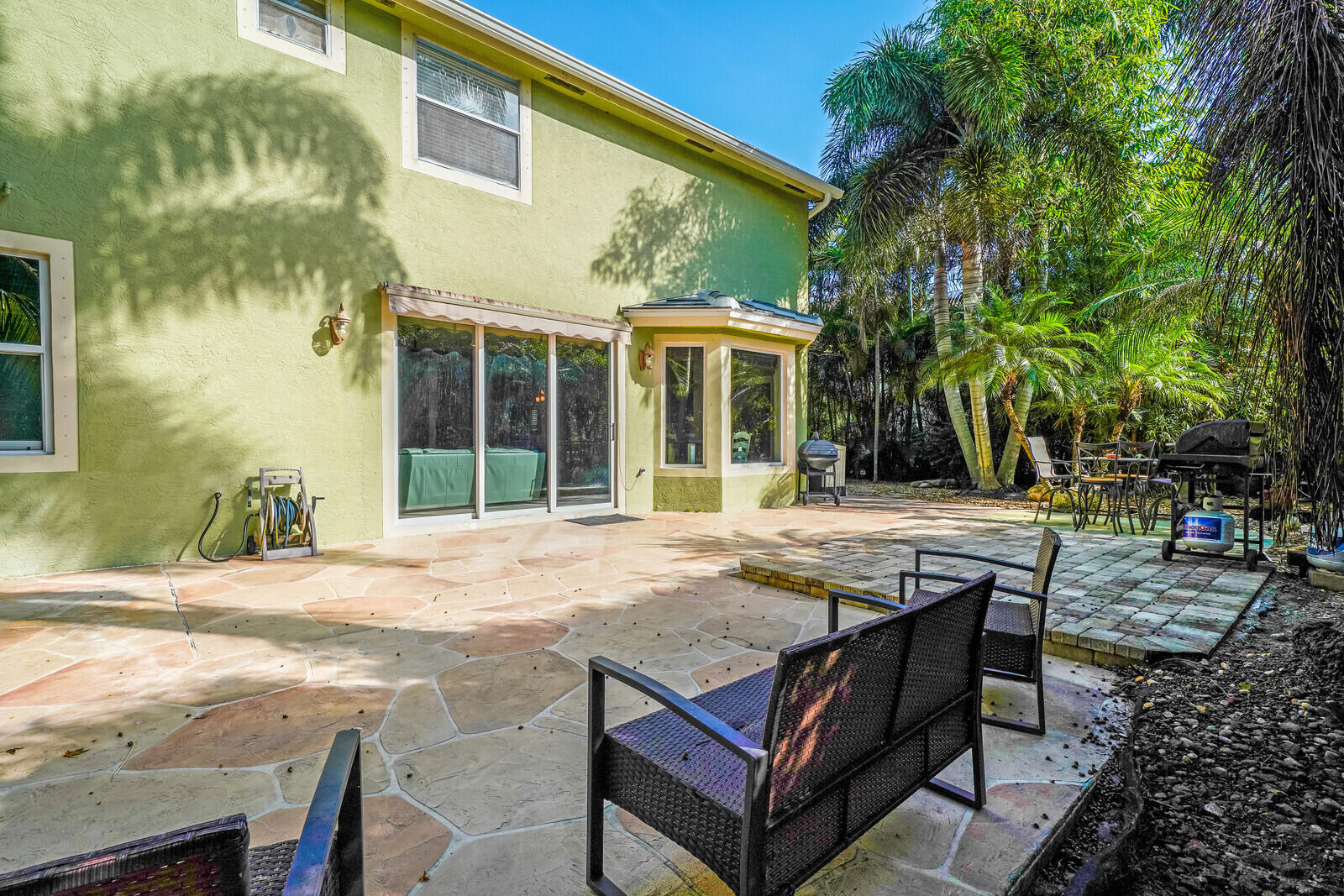 202 Anhinga Lane Jupiter, FL 33458 - Photo 38 of 40 a view of a dinning table and chairs in patio