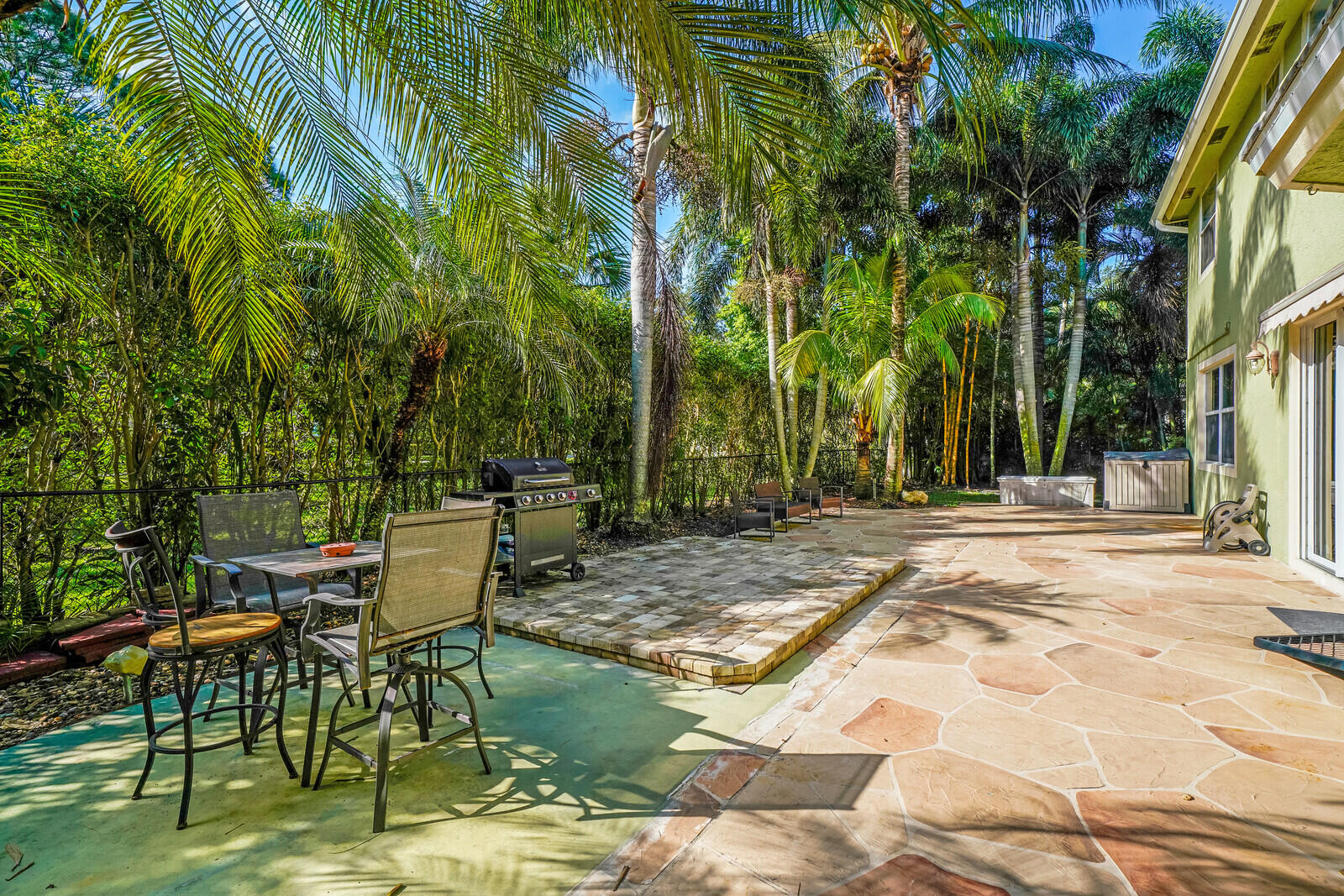 202 Anhinga Lane Jupiter, FL 33458 - Photo 39 of 40 a view of backyard with table and chairs and potted plants