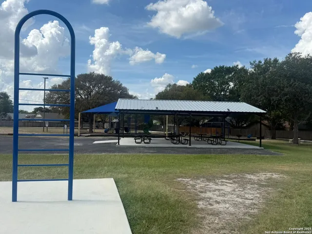a view of a house with swimming pool and a yard