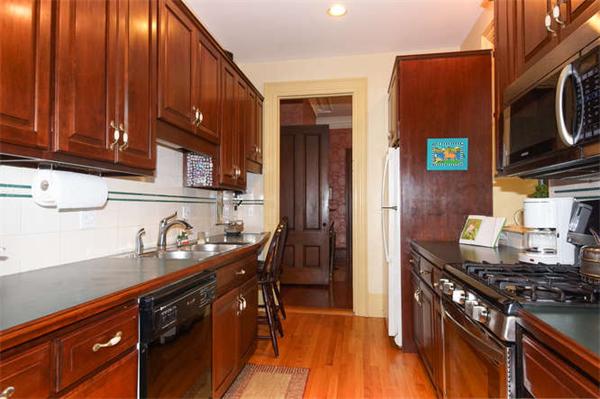 42 Rangeley Road Winchester, MA 01890 - Photo 7 of 30 a kitchen with stainless steel appliances a stove a sink dishwasher and cabinets with wooden floor