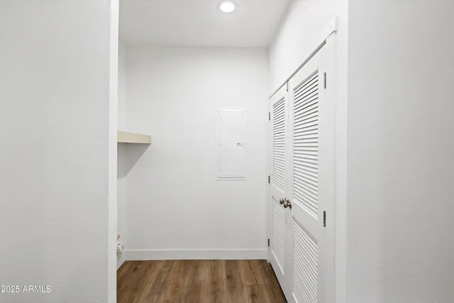 wooden floor in an empty room with a window