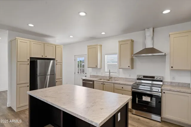 a kitchen with stainless steel appliances granite countertop a sink stove and refrigerator