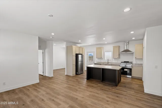 a view of kitchen with refrigerator stove microwave and cabinets