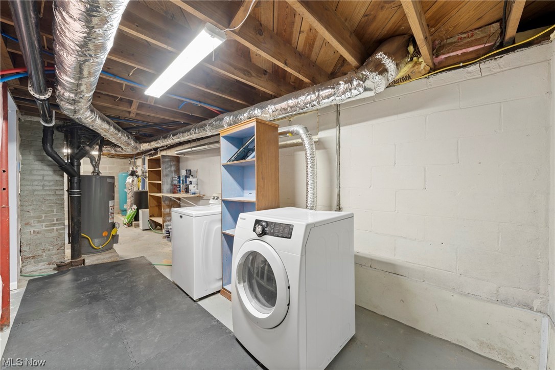 227 South Messner Road New Franklin, OH 44319 - Photo 43 of 44 Laundry area featuring brick wall, water heater, and separate washer and dryer