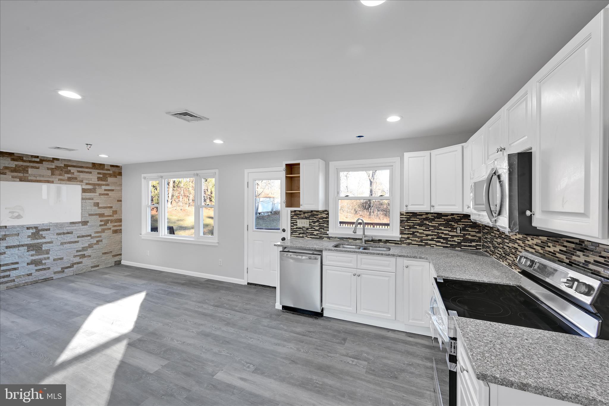 2509 Mill Road Mechanicsburg, PA 17055 - Photo 13 of 43 a kitchen with stainless steel appliances granite countertop a stove a sink and a refrigerator