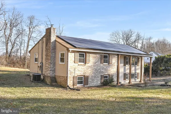 a view of a house with a yard and sitting area