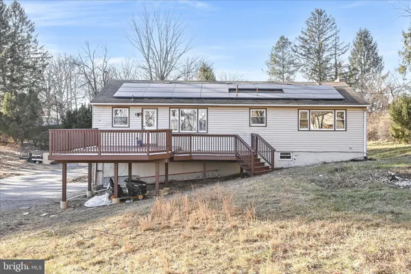 a view of a house with a yard and furniture