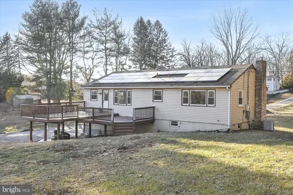 a view of a house with a yard and sitting area
