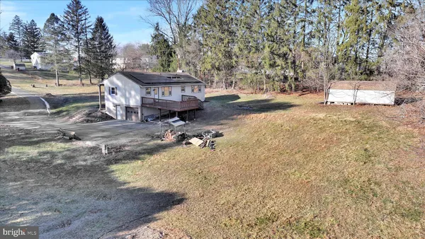 a view of a house with a yard and sitting area