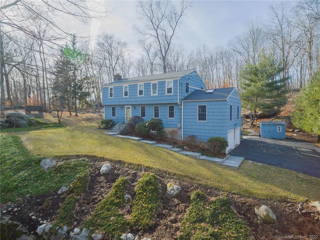 a view of a house with a yard covered with snow in the background