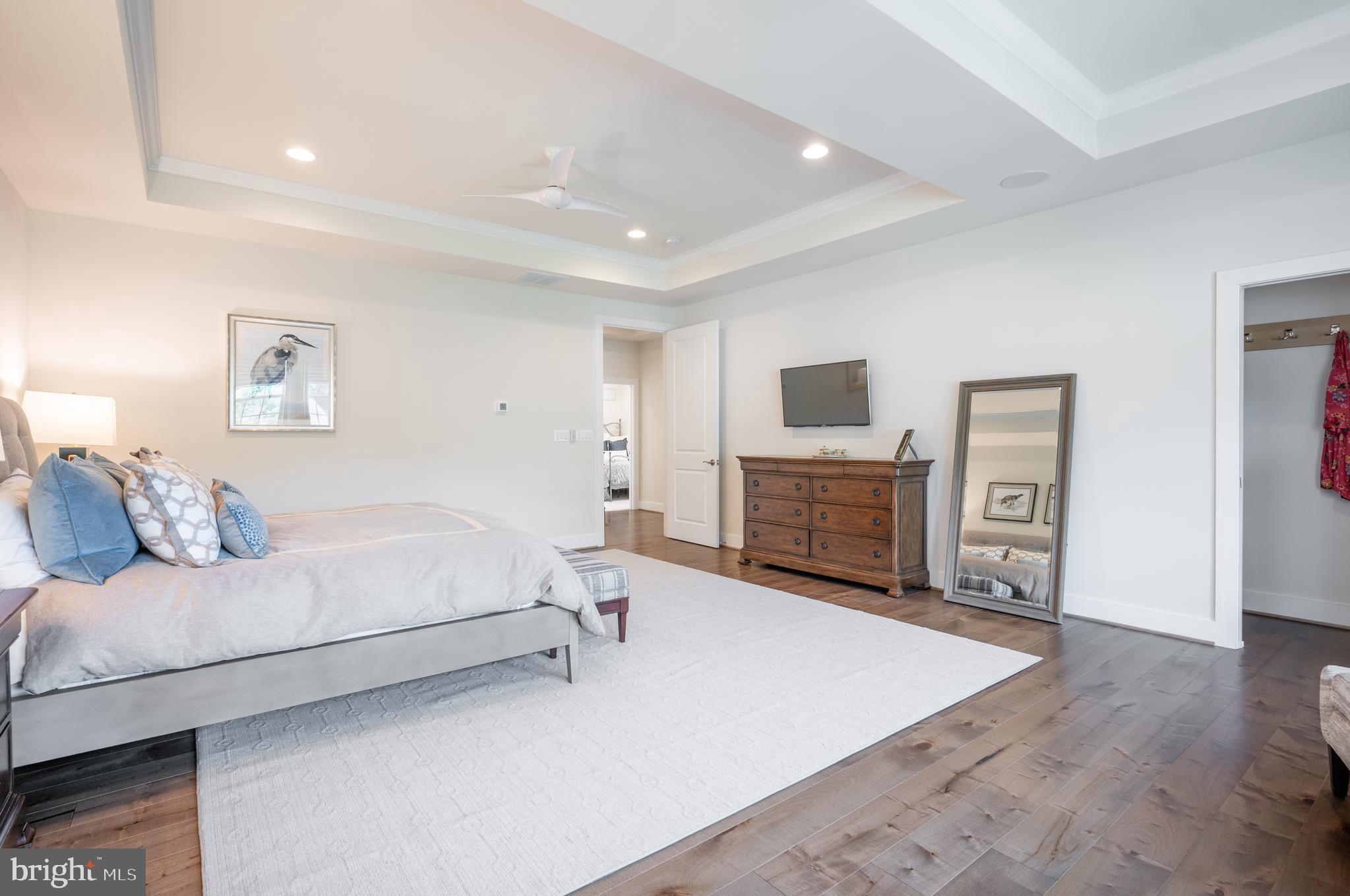 6233 McConnell Lane Springfield, VA 22152 - Photo 29 of 58 a spacious bedroom with a bed and a flat screen tv