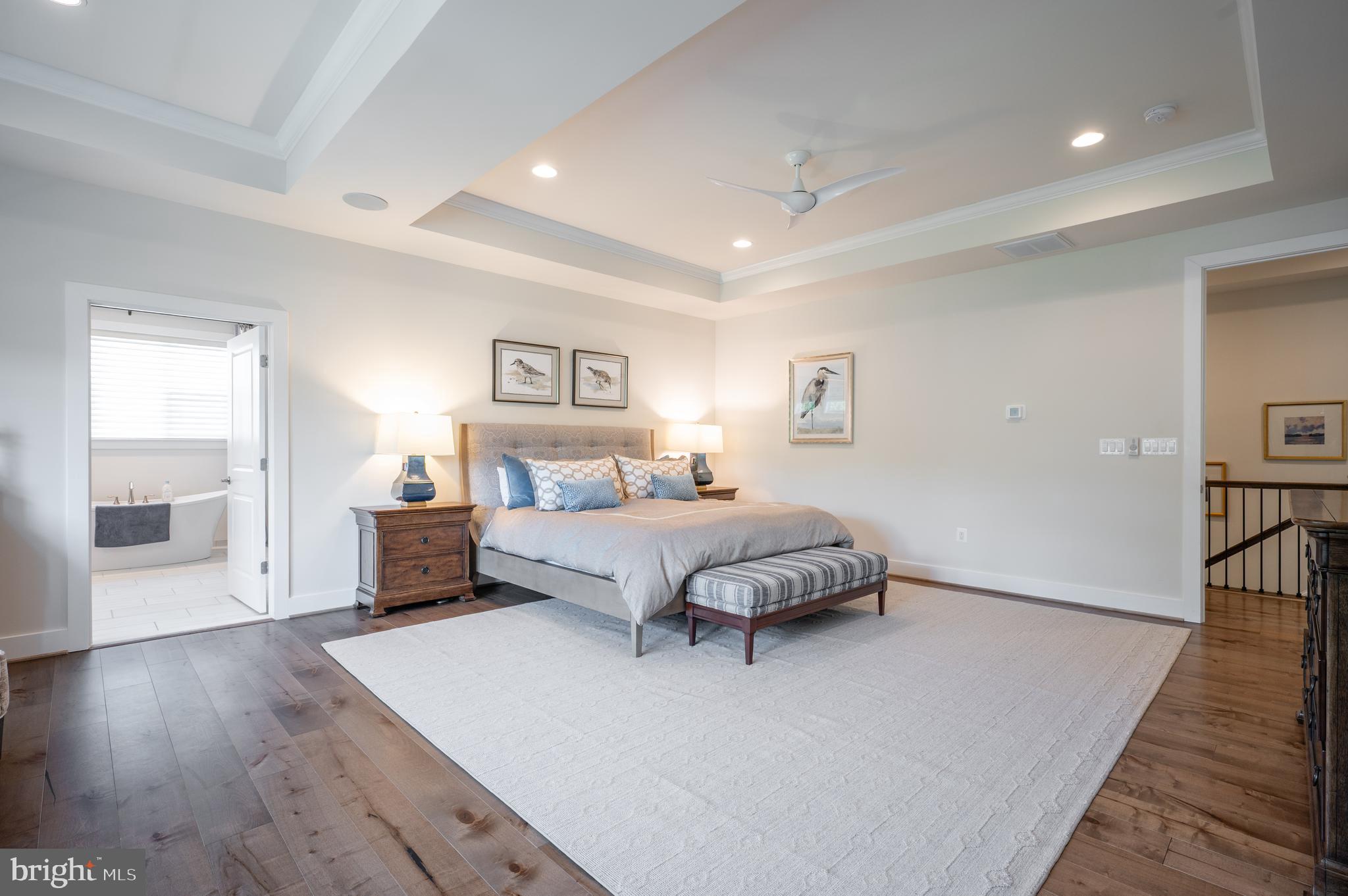 6233 McConnell Lane Springfield, VA 22152 - Photo 30 of 58 a bedroom with a large bed and a wooden floor