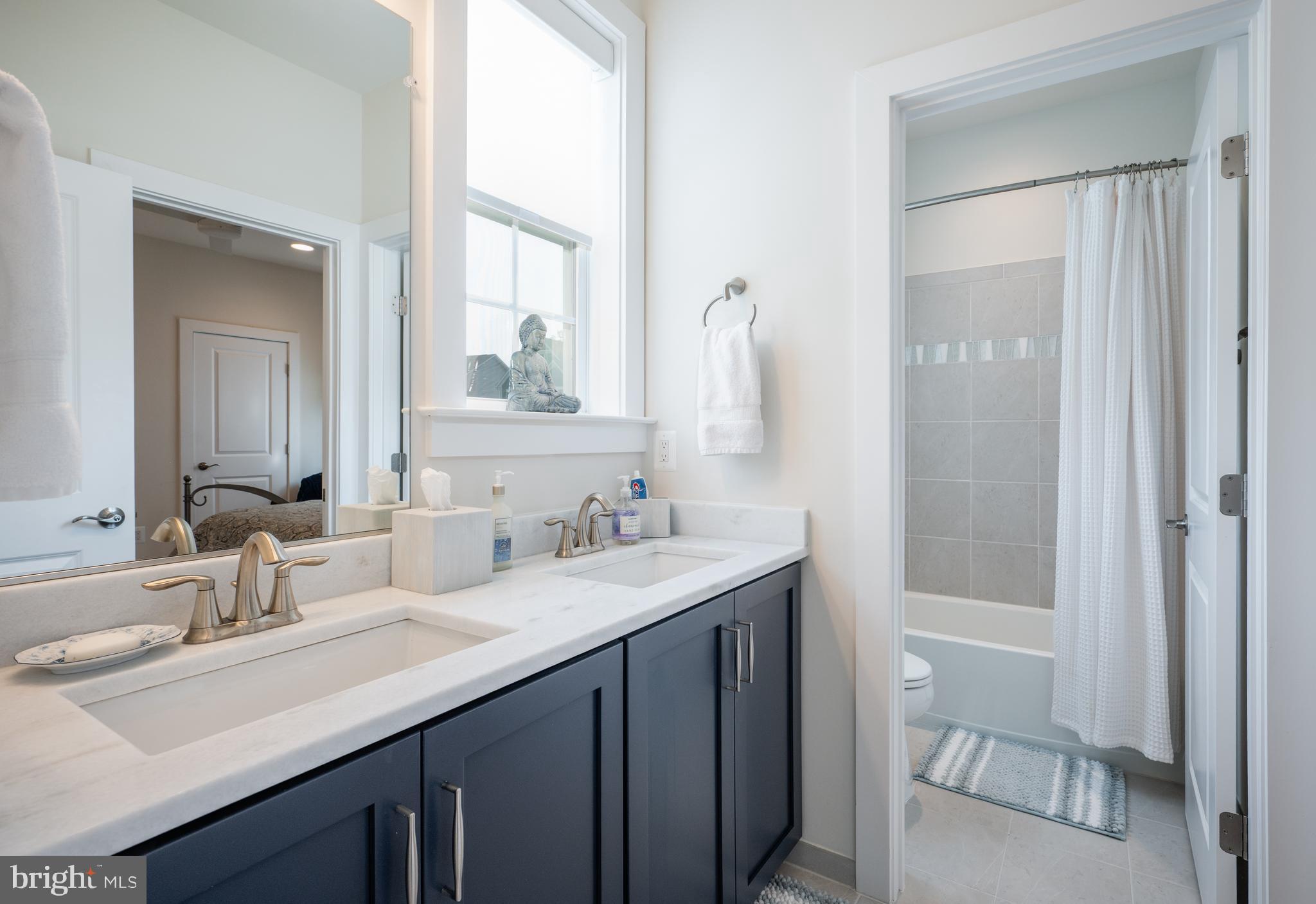 6233 McConnell Lane Springfield, VA 22152 - Photo 36 of 58 a bathroom with a sink a toilet and shower