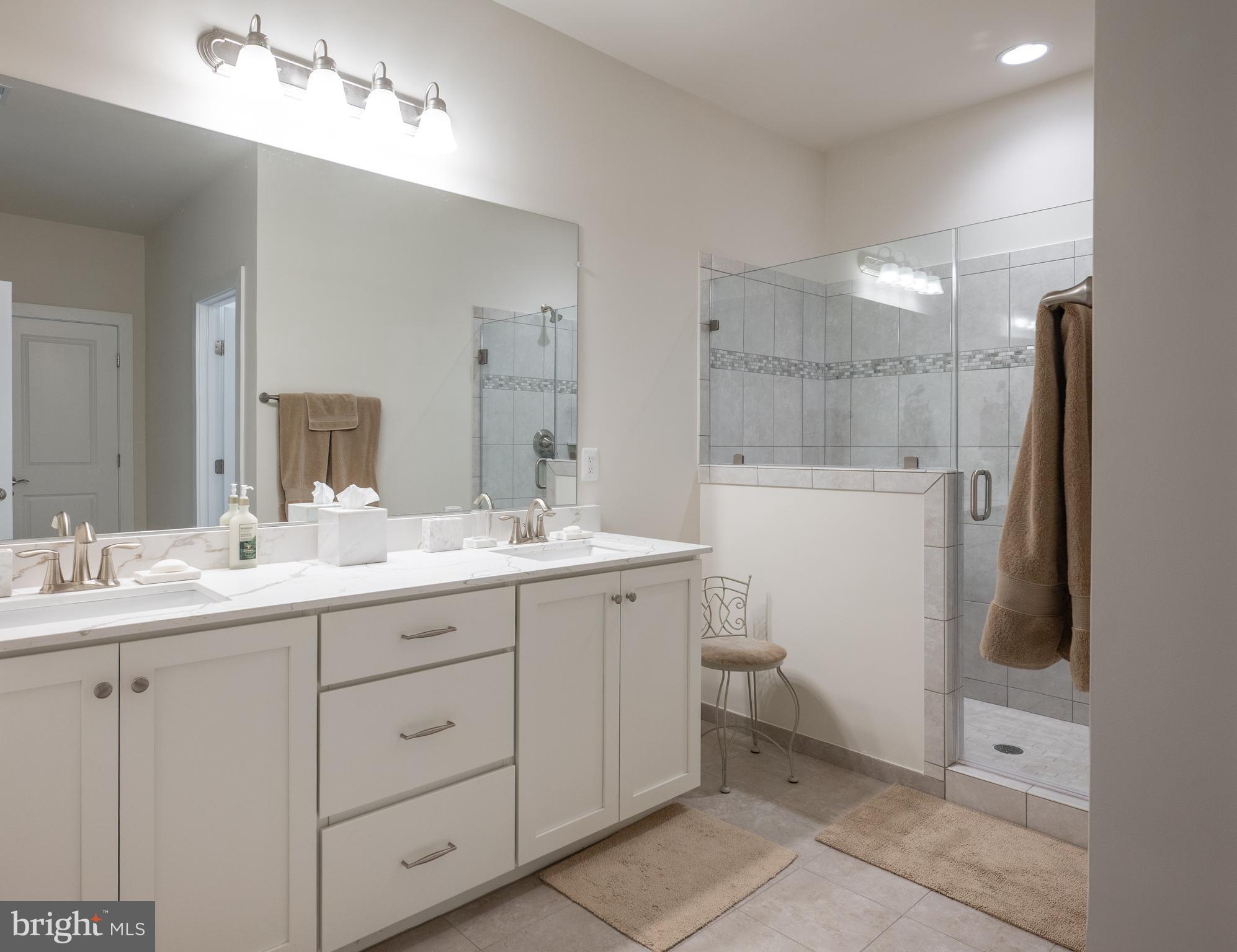6233 McConnell Lane Springfield, VA 22152 - Photo 42 of 58 a bathroom with a double vanity sink and mirror