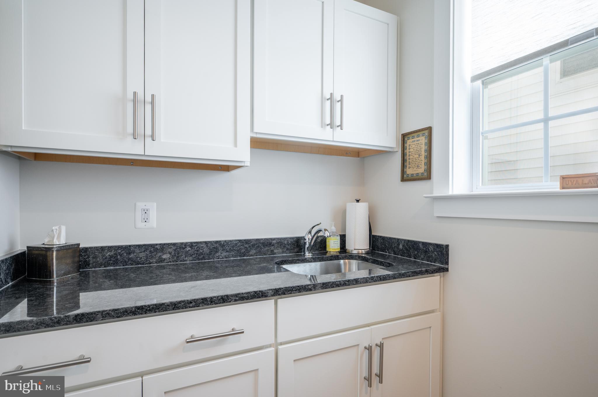 6233 McConnell Lane Springfield, VA 22152 - Photo 45 of 58 a kitchen with granite countertop white cabinets and a sink