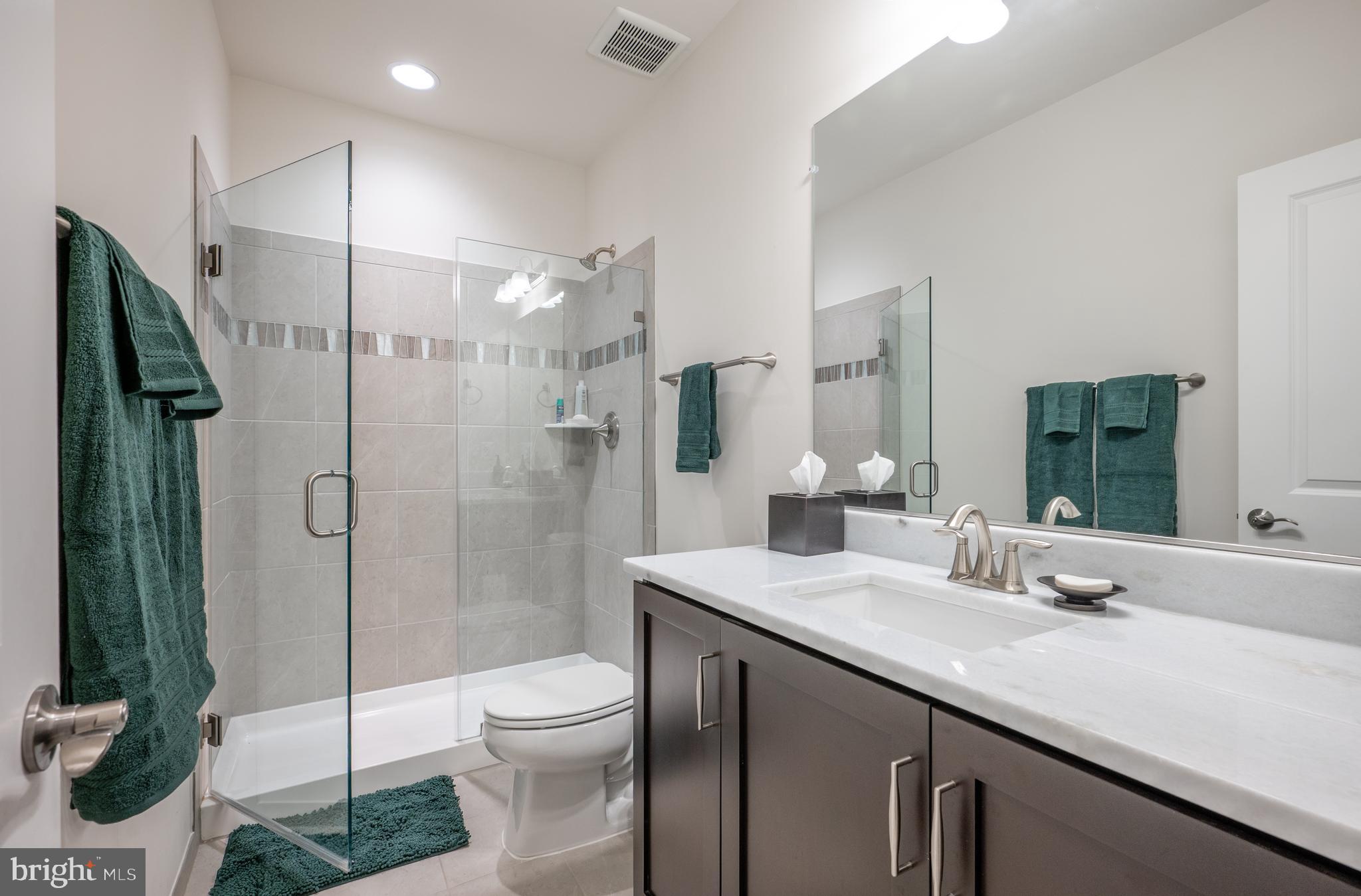6233 McConnell Lane Springfield, VA 22152 - Photo 53 of 58 a bathroom with a granite countertop sink toilet and shower