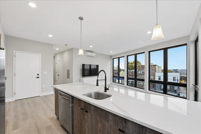 a large white kitchen with a large window