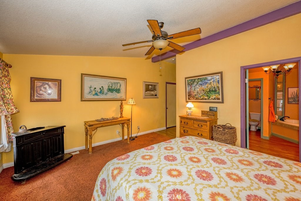 33330 Palen Road Agua Dulce, CA 91390 - Photo 17 of 56 a bedroom with a bed and dresser with chair