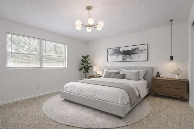 a bedroom with a bed and a chandelier