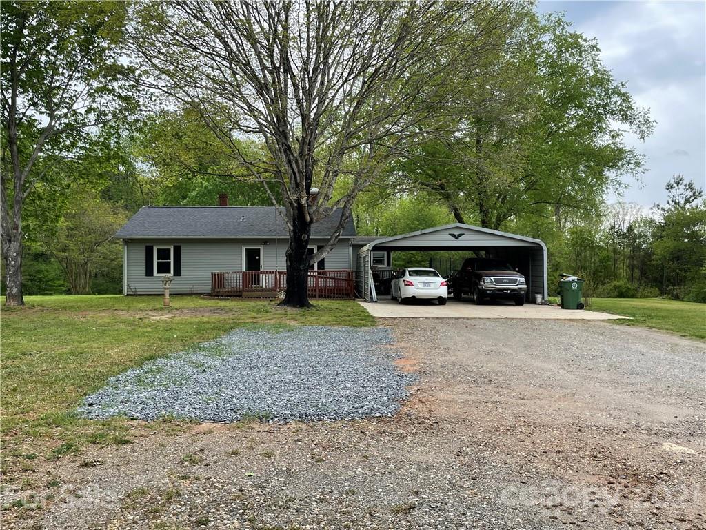 622 Loray Farm Road Dallas, NC 28034 - Photo 1 of 15 a front view of a house with a garden and trees