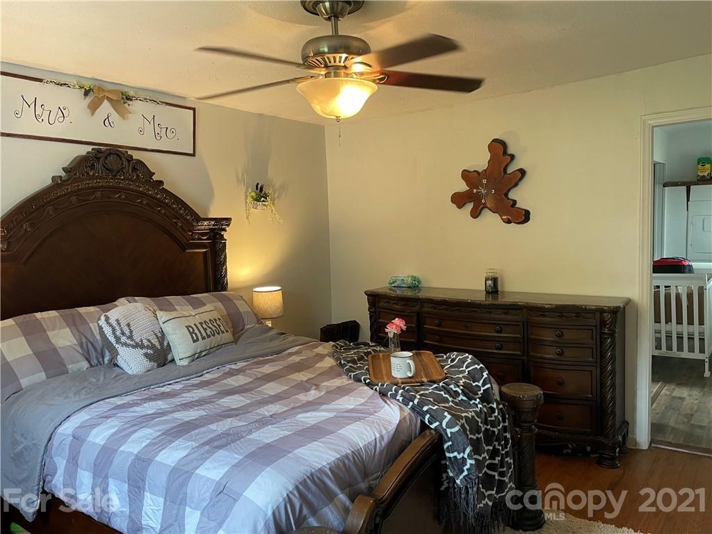 622 Loray Farm Road Dallas, NC 28034 - Photo 14 of 15 a bedroom with a bed and a chandelier