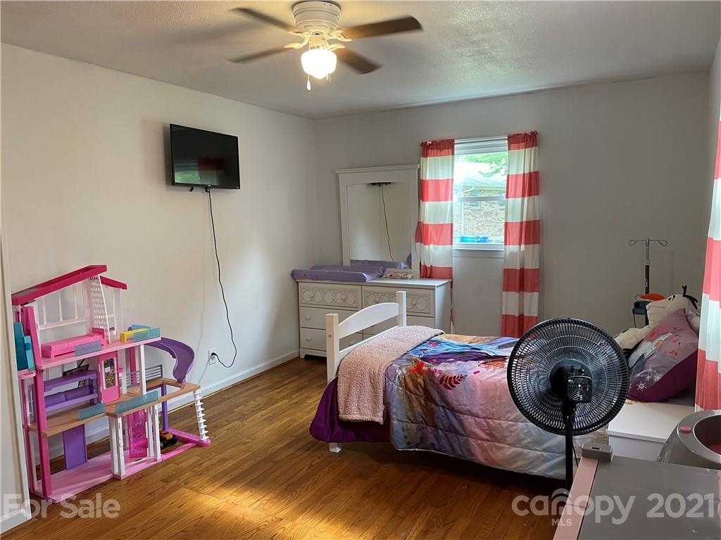 622 Loray Farm Road Dallas, NC 28034 - Photo 10 of 15 a bedroom with a bed and a chandelier