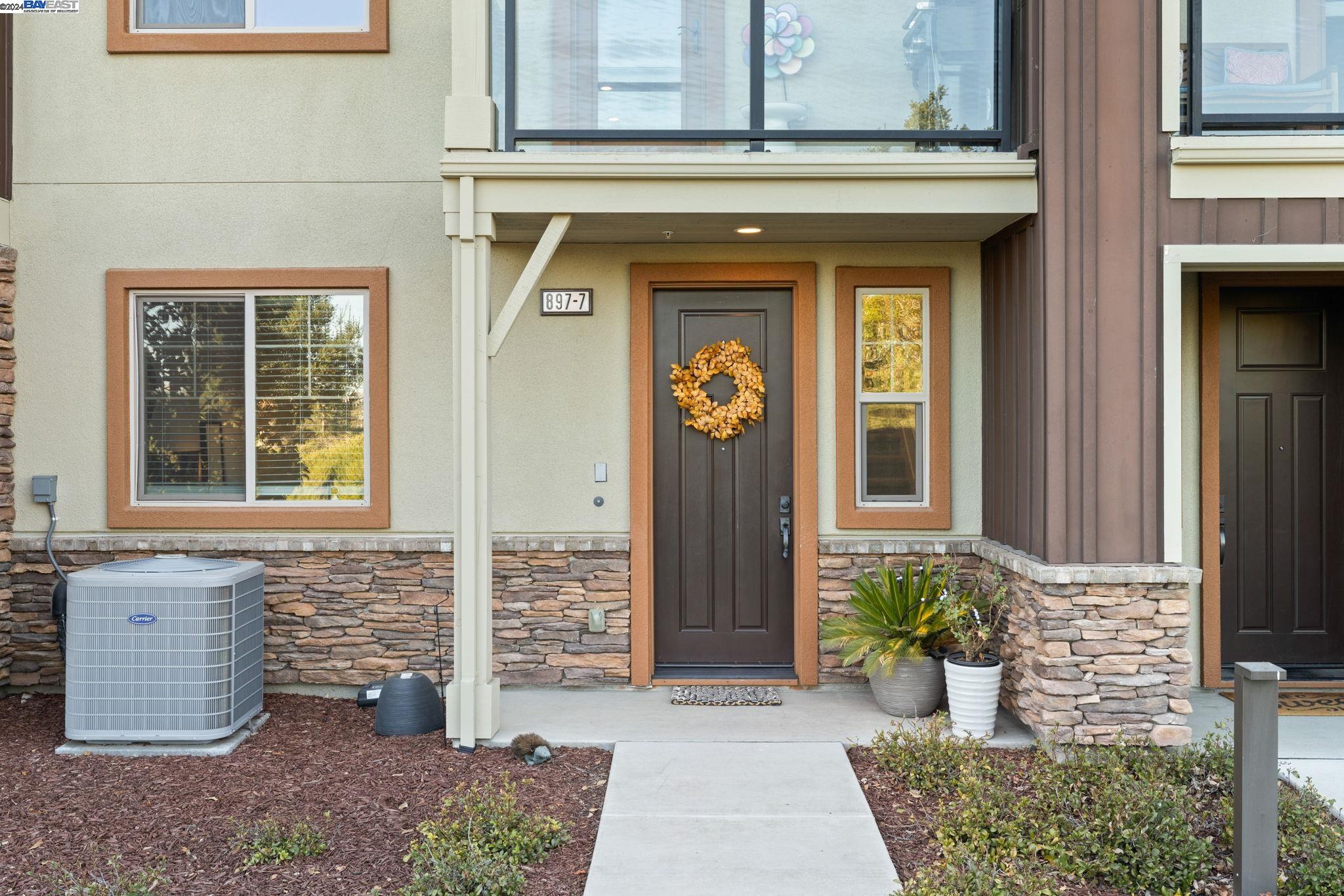 a front view of a house with potted plants