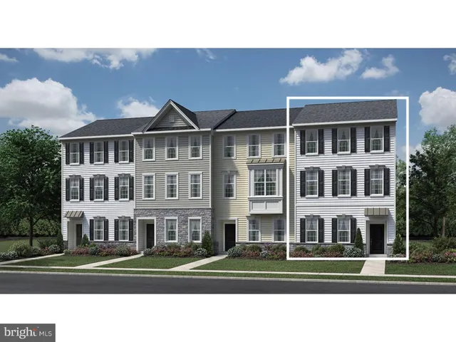 a front view of a building with a yard